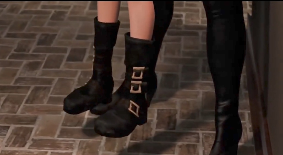 a man with a goatee smiles while talking on a cell phone